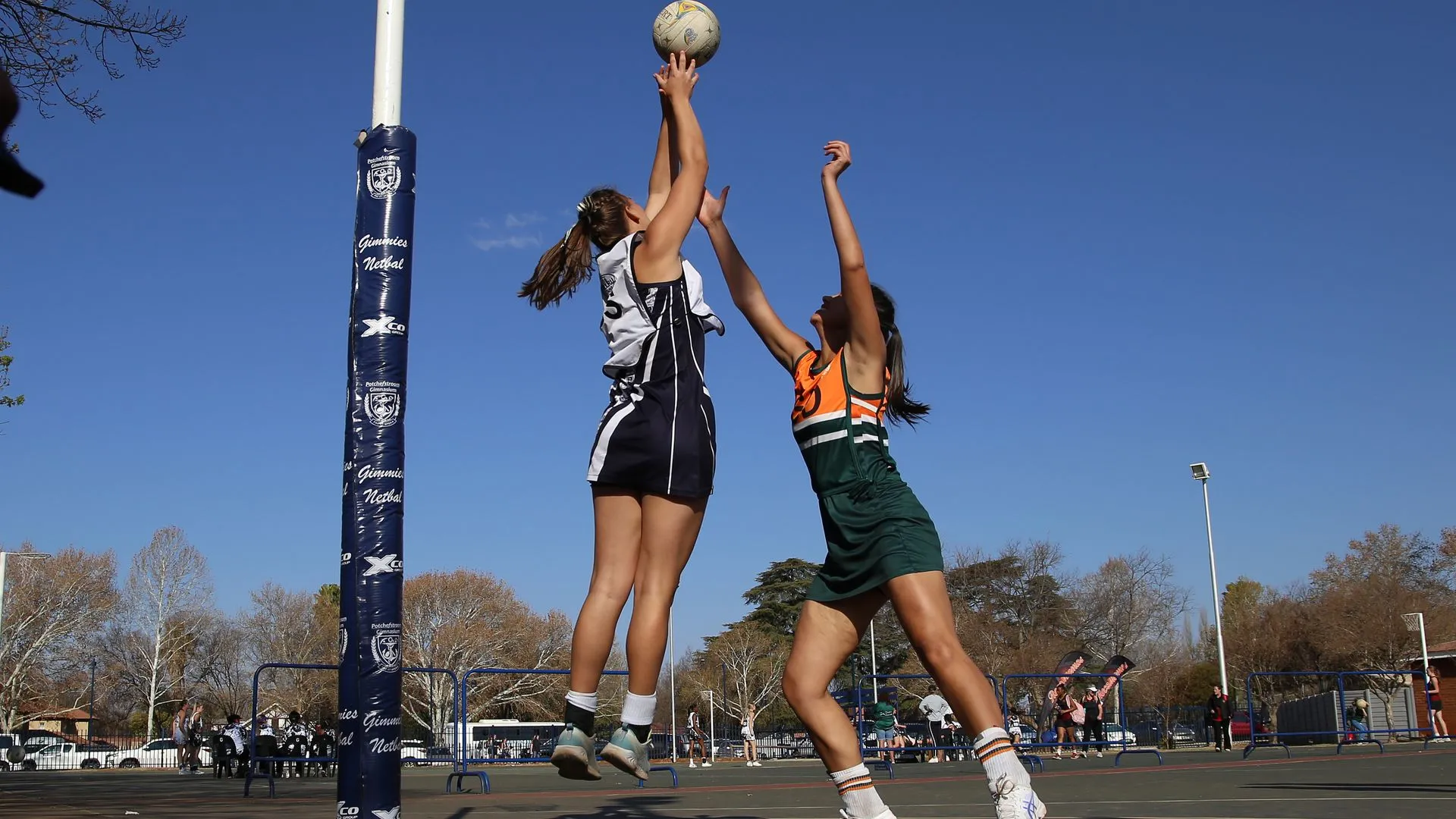 Netball players contesting the ball